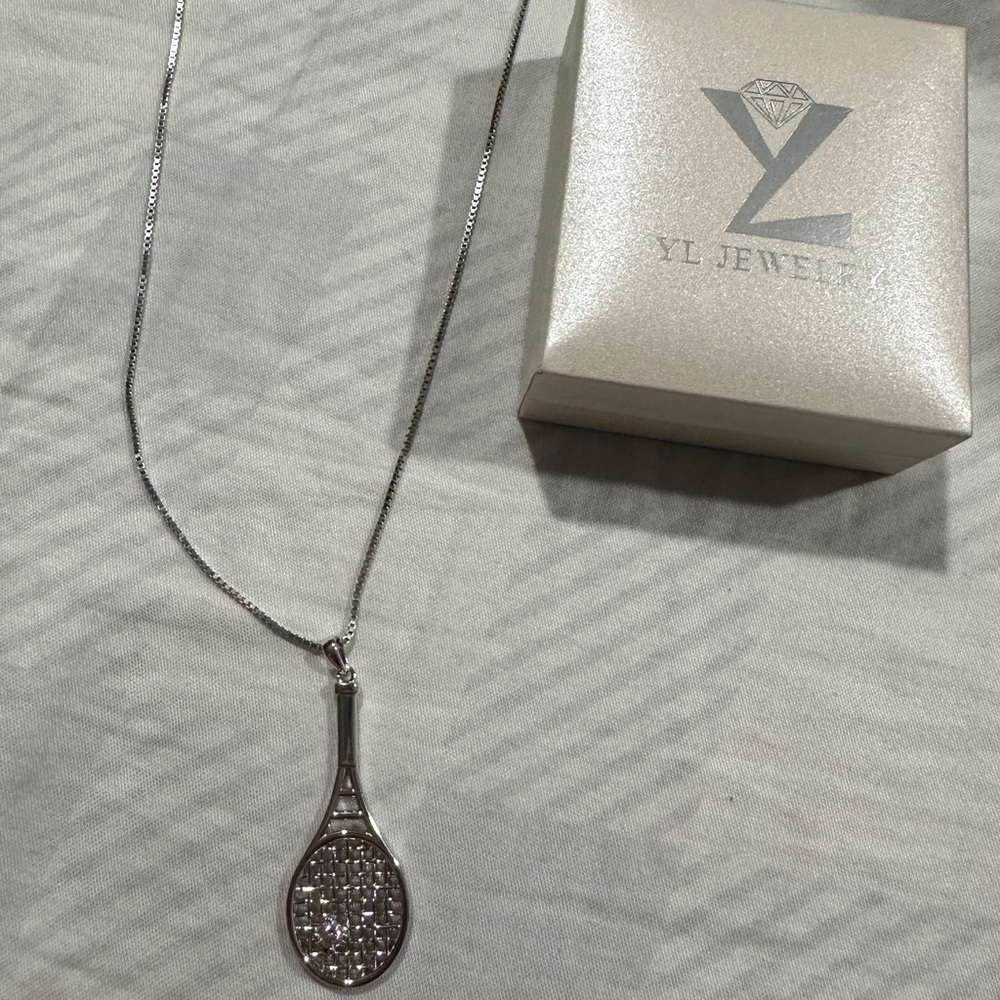 Tennis necklace with pink gem.